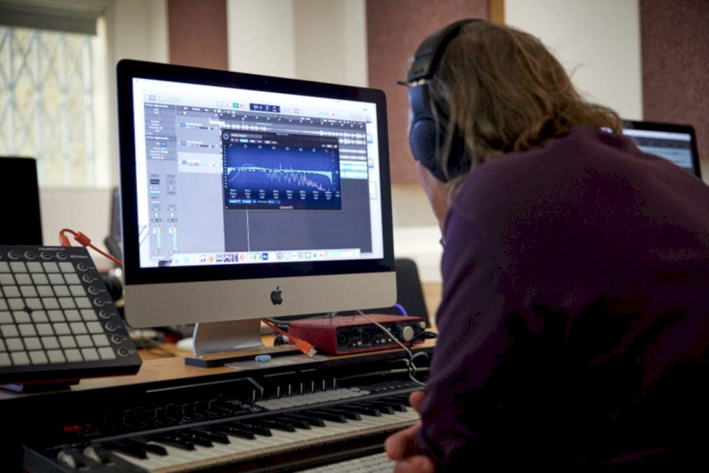 Student editing music on a screen