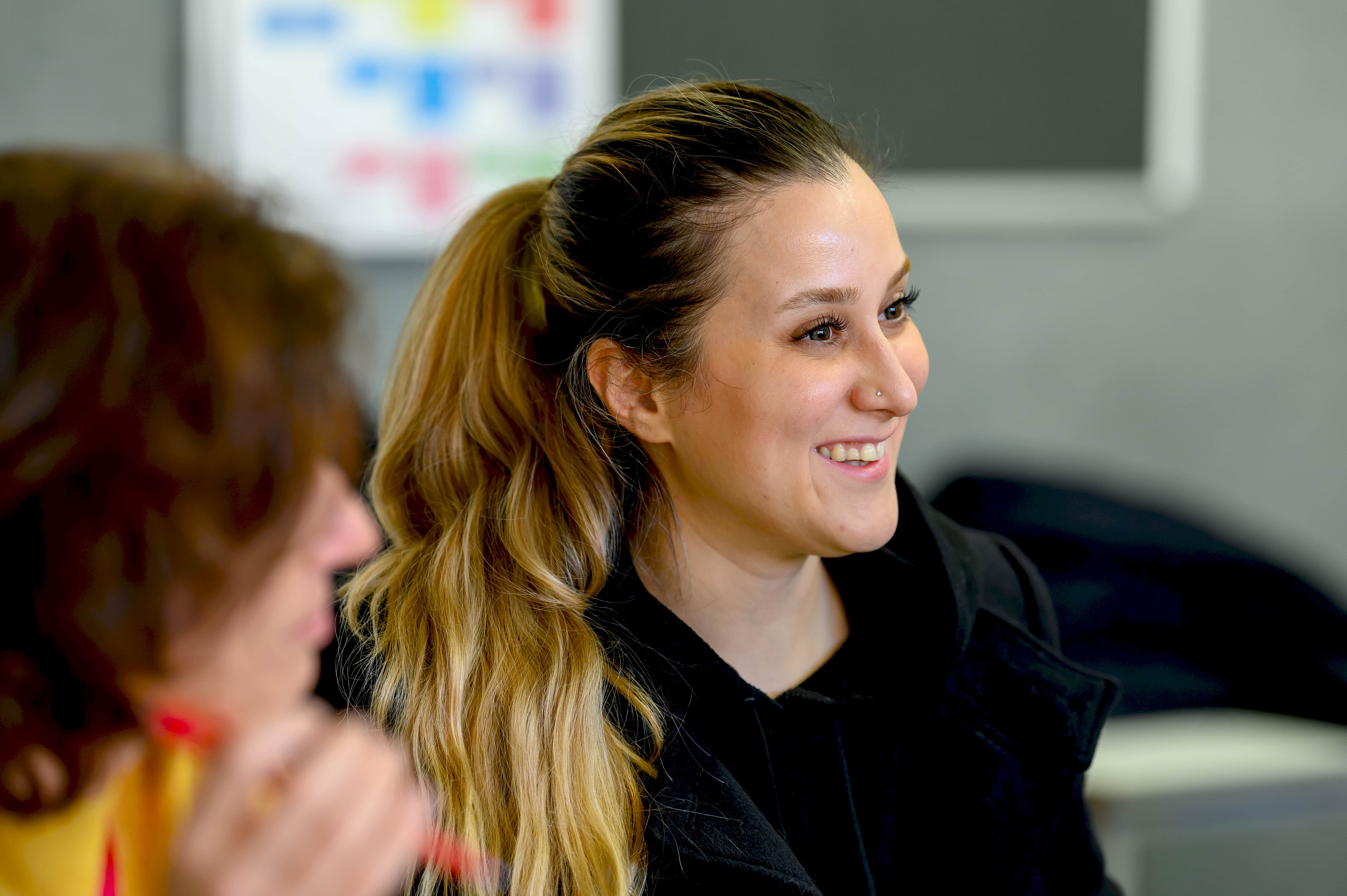 Young women smiling in class