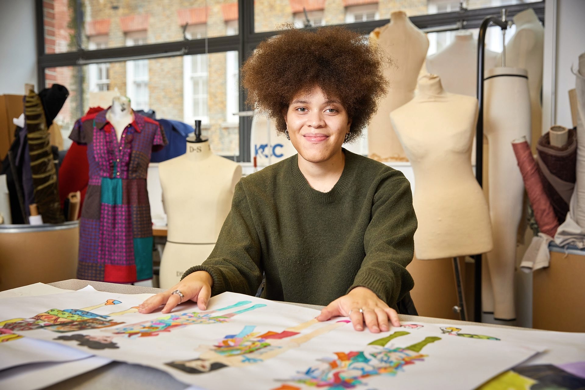 Young black female student sitting in fashion studio