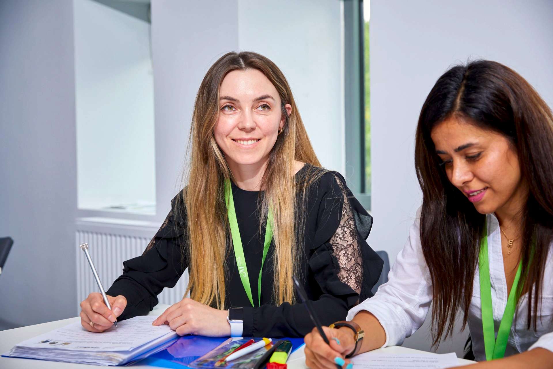 Two female adult students in classroom