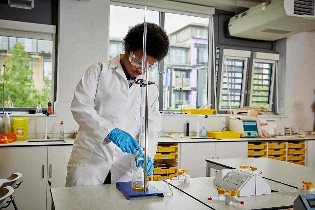 Black male student working in science lab