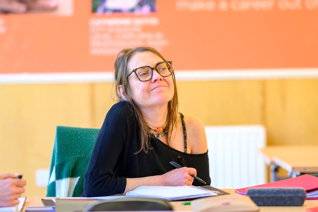Student making notes in a classroom