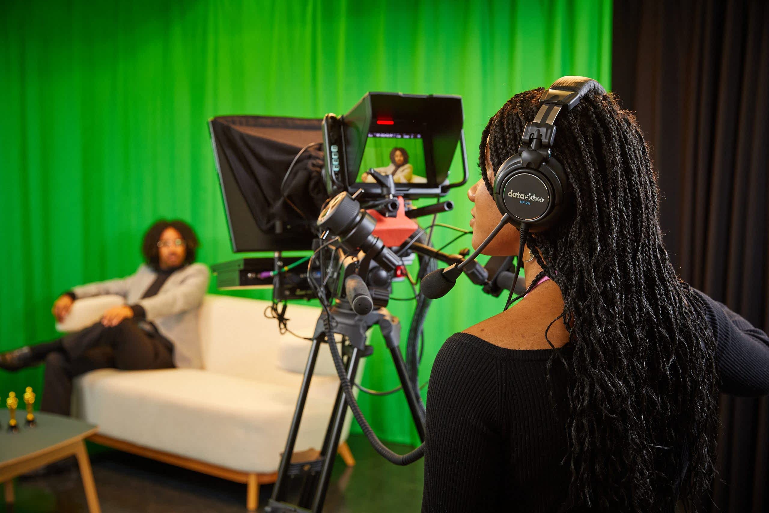 Female student filming in the mock TV studio